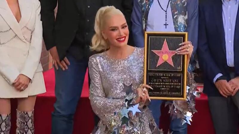Gwen Stefani accepted the honor Thursday, flanked by husband Blake Shelton and her three sons.