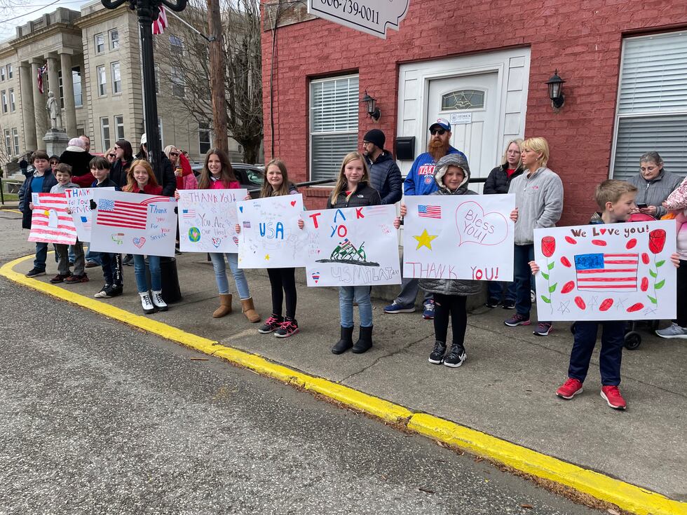 Students who attend Ponderosa Elementary in Catlettsburg, Ky hold handmade signs in honor of...