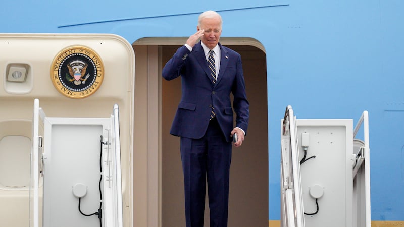 President Joe Biden returns a salute as he boards Air Force One at Andrews Air Force Base,...