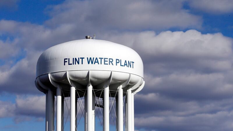 In this March 21, 2016, file photo, the Flint Water Plant water tower is seen in Flint, Mich....