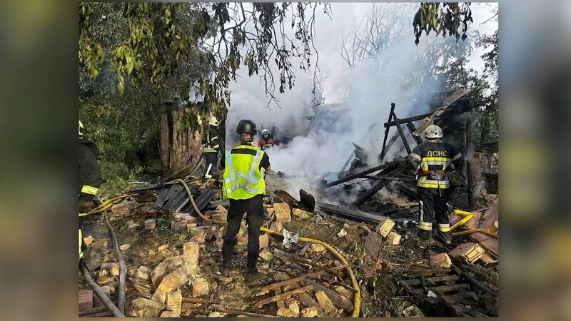 Debris and smoke is seen in the aftermath of an attack on Kyiv on Wednesday.