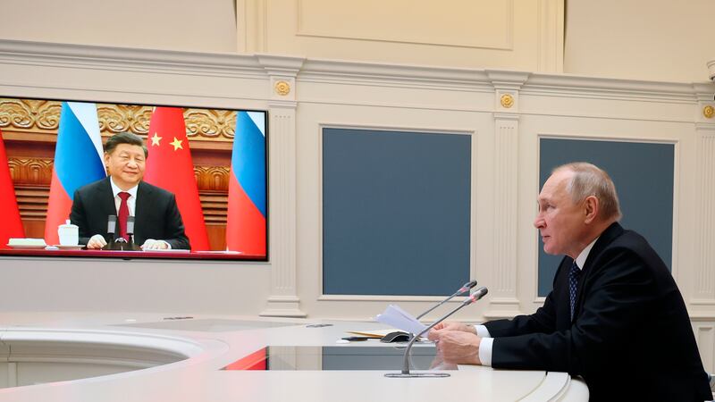 Russian President Vladimir Putin speaks during a meeting with Chinese President Xi Jinping,...